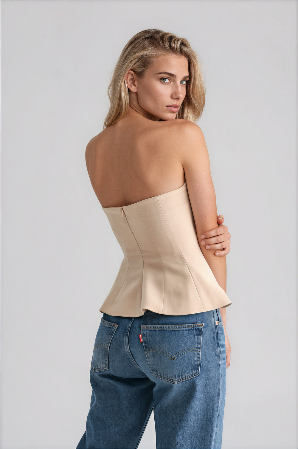 becca top back view in beige strapless bustier with zipper