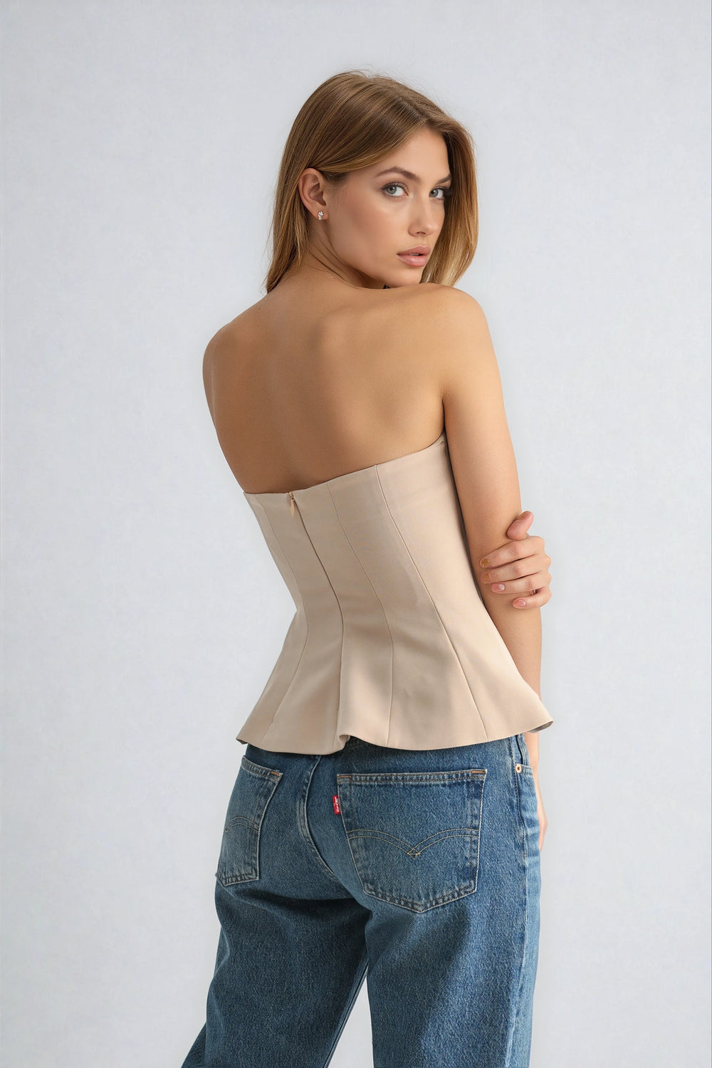becca top back view in beige strapless bustier with zipper
