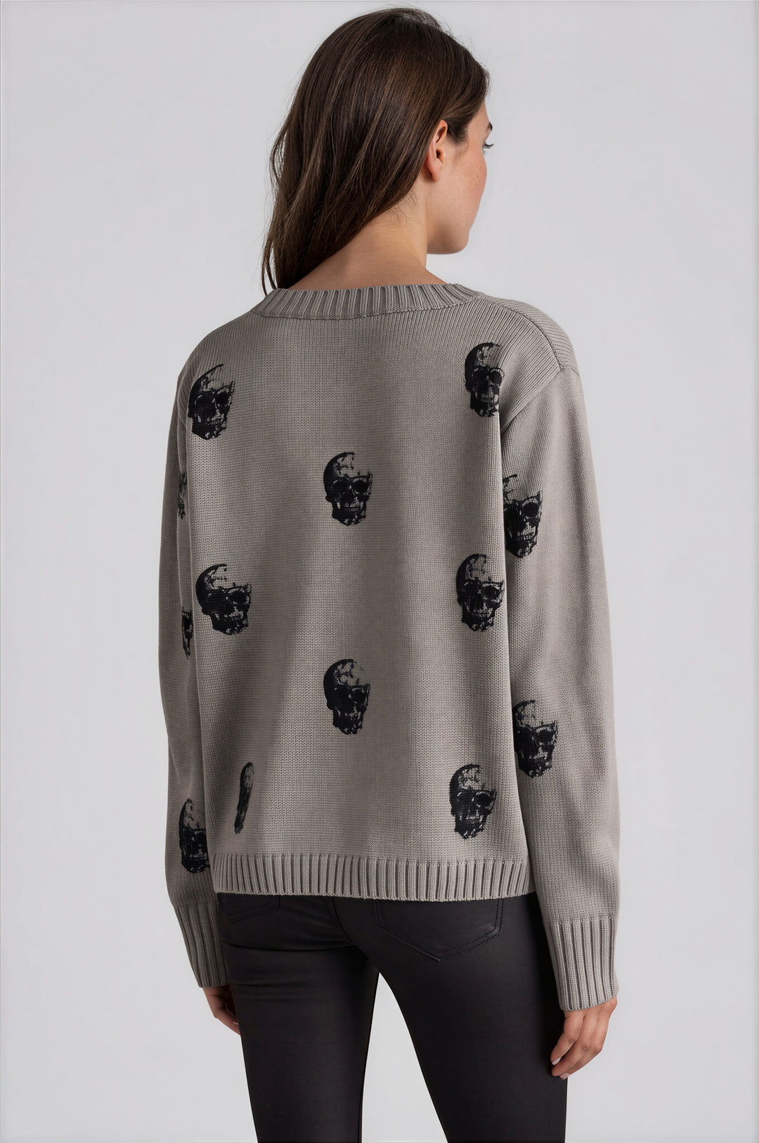 Gray sweater with black skull pattern and crew neckline