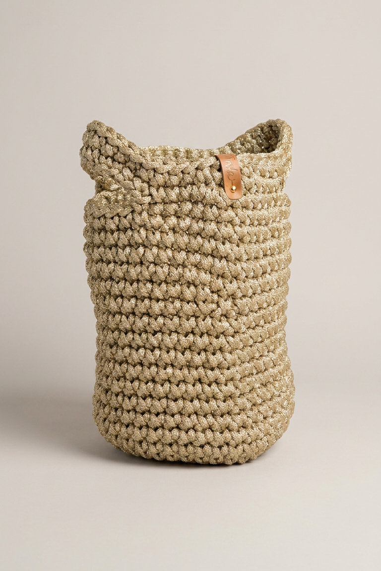 Twyla Gold Crochet Top Handle Bag standing upright, showing structured silhouette and leather tag