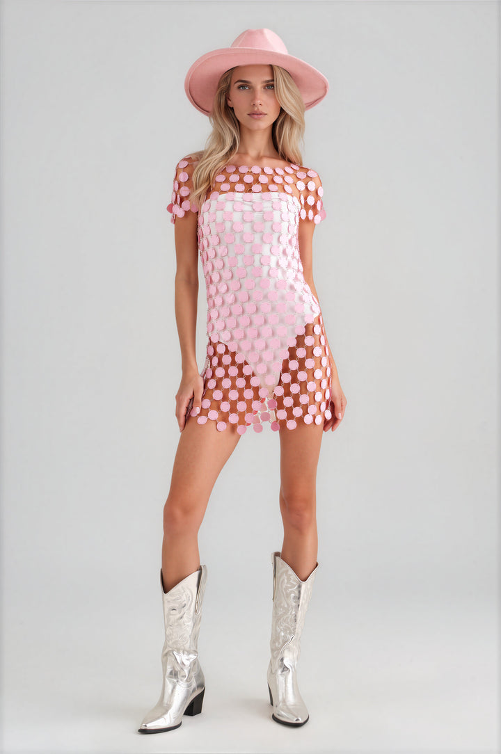 Woman wearing pink disc paillette sequin sheer mini dress with short sleeves