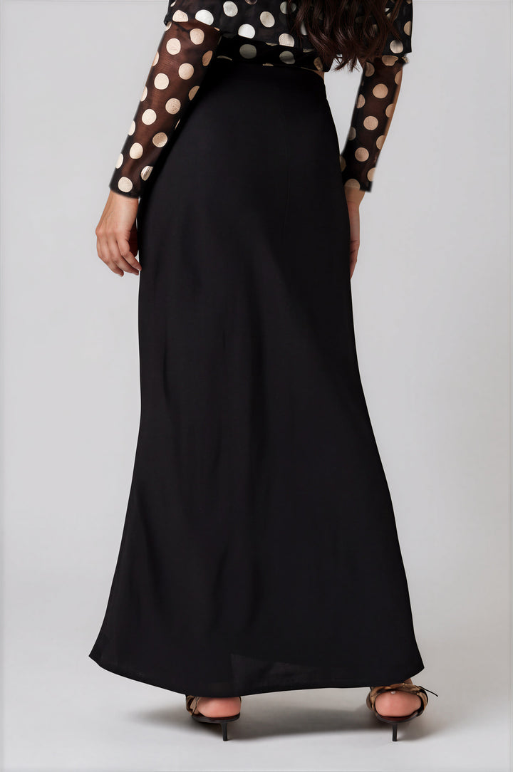 Back view black high waisted satin skirt on model