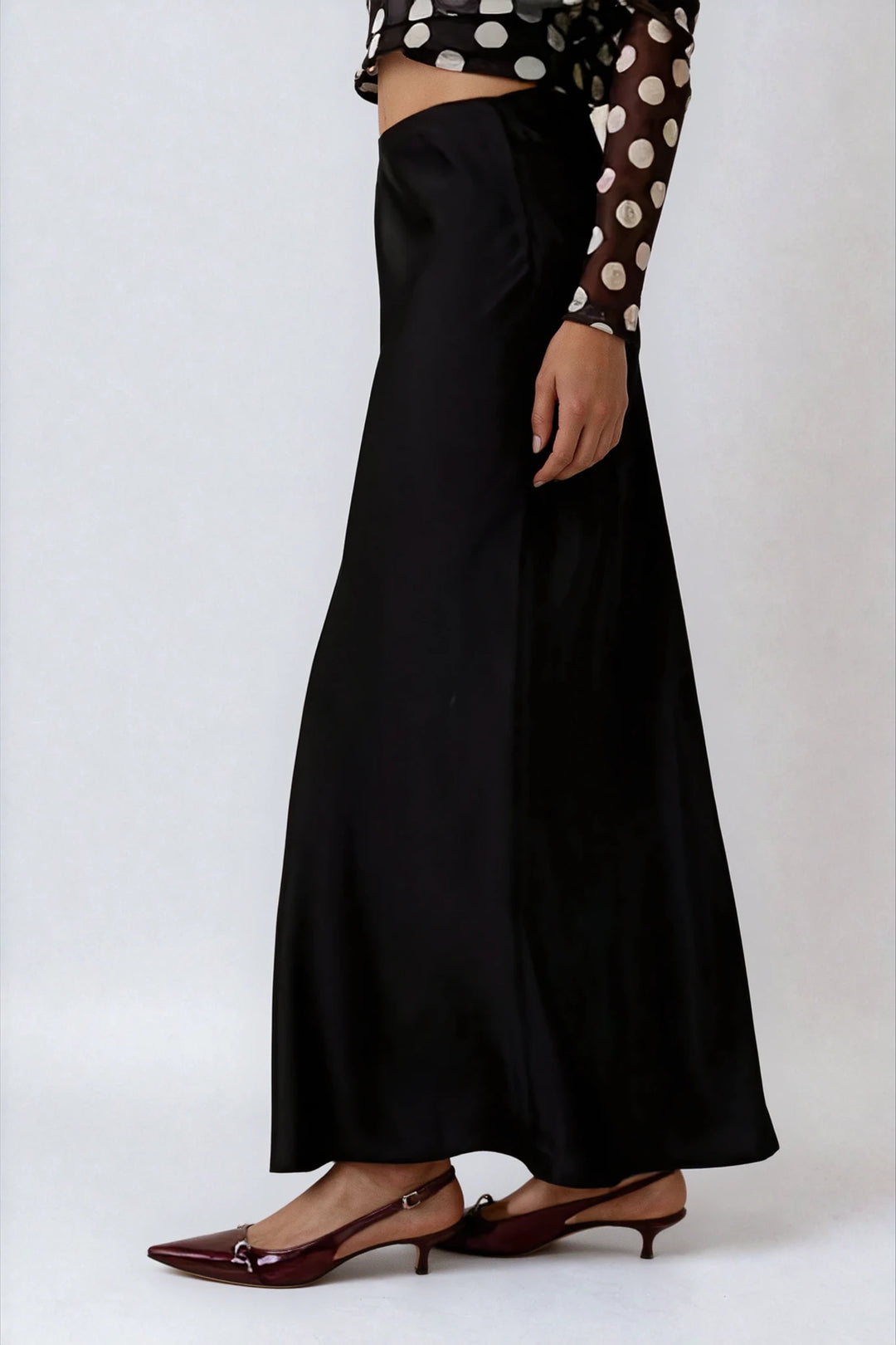 Side view black satin maxi skirt with lightweight sheen