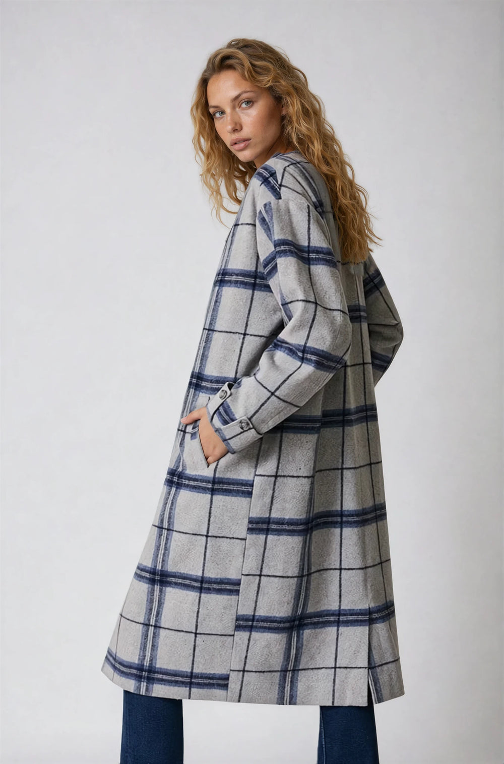 Off white sleeveless swing top with tweed finish on model