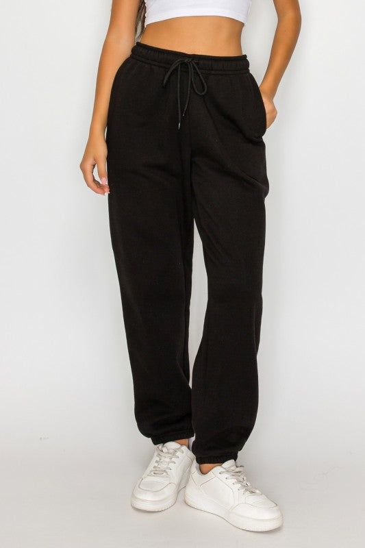 Front view black fleece sweatpants with drawstring waistband