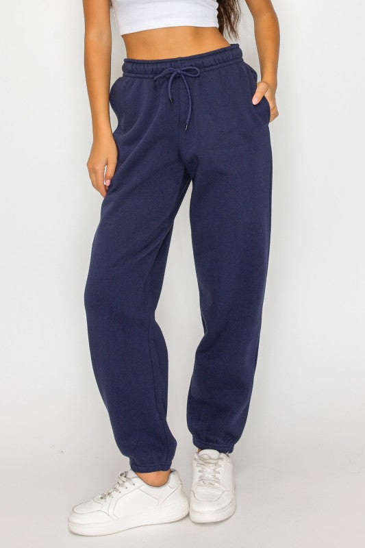 Front view navy fleece sweatpants with drawstring waistband