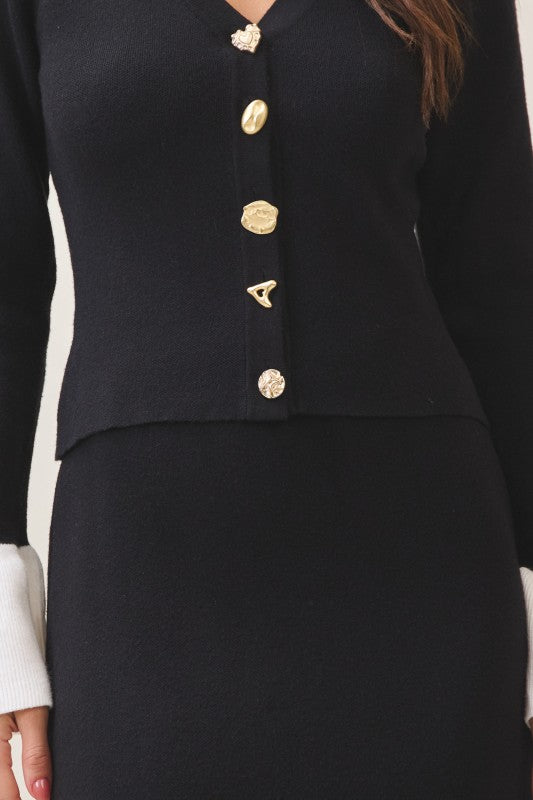 Front view black knit set with jewel buttons and contrast cuffs