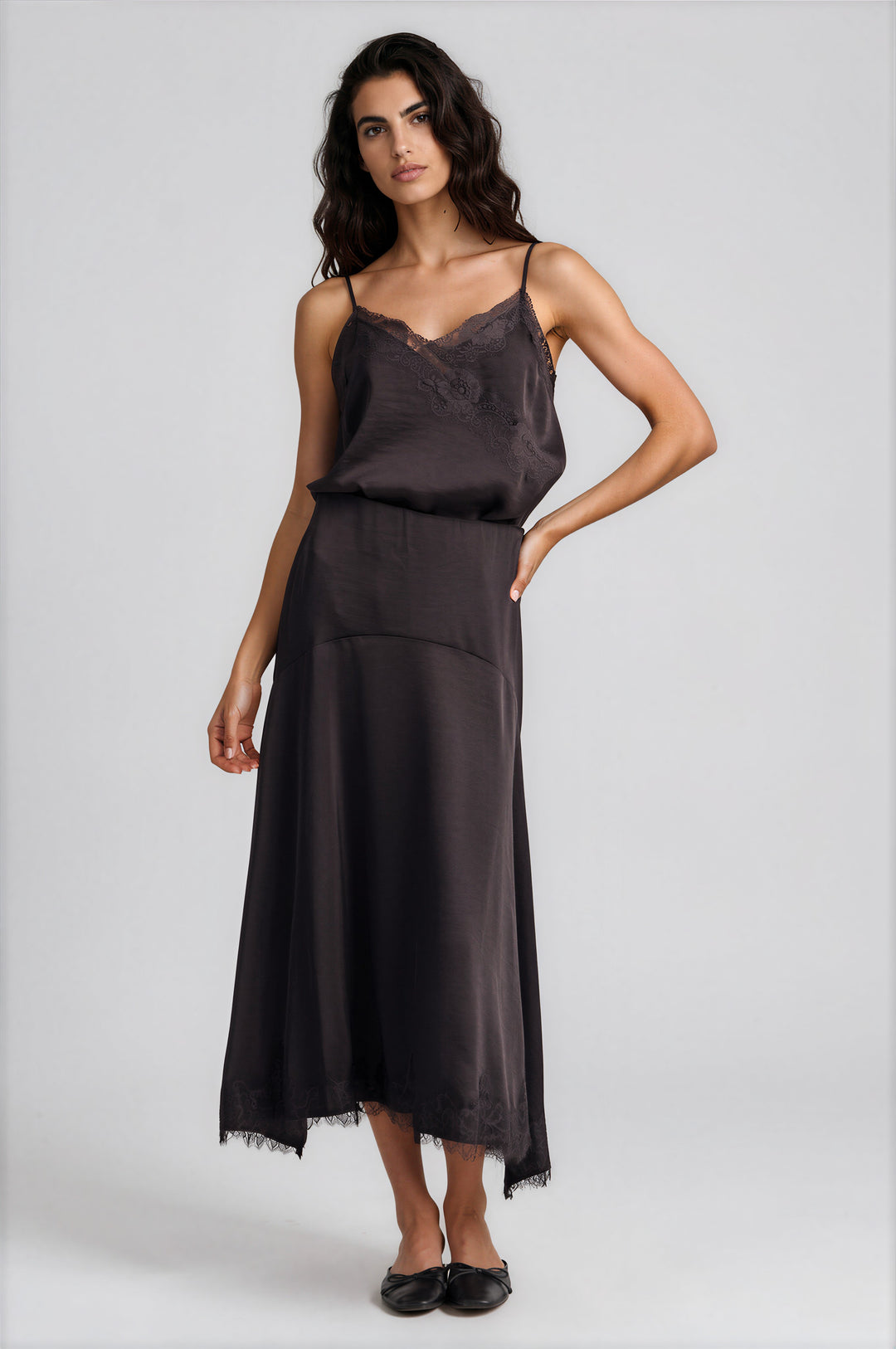 Chocolate satin asymmetric slip skirt with a scalloped lace hem, front view