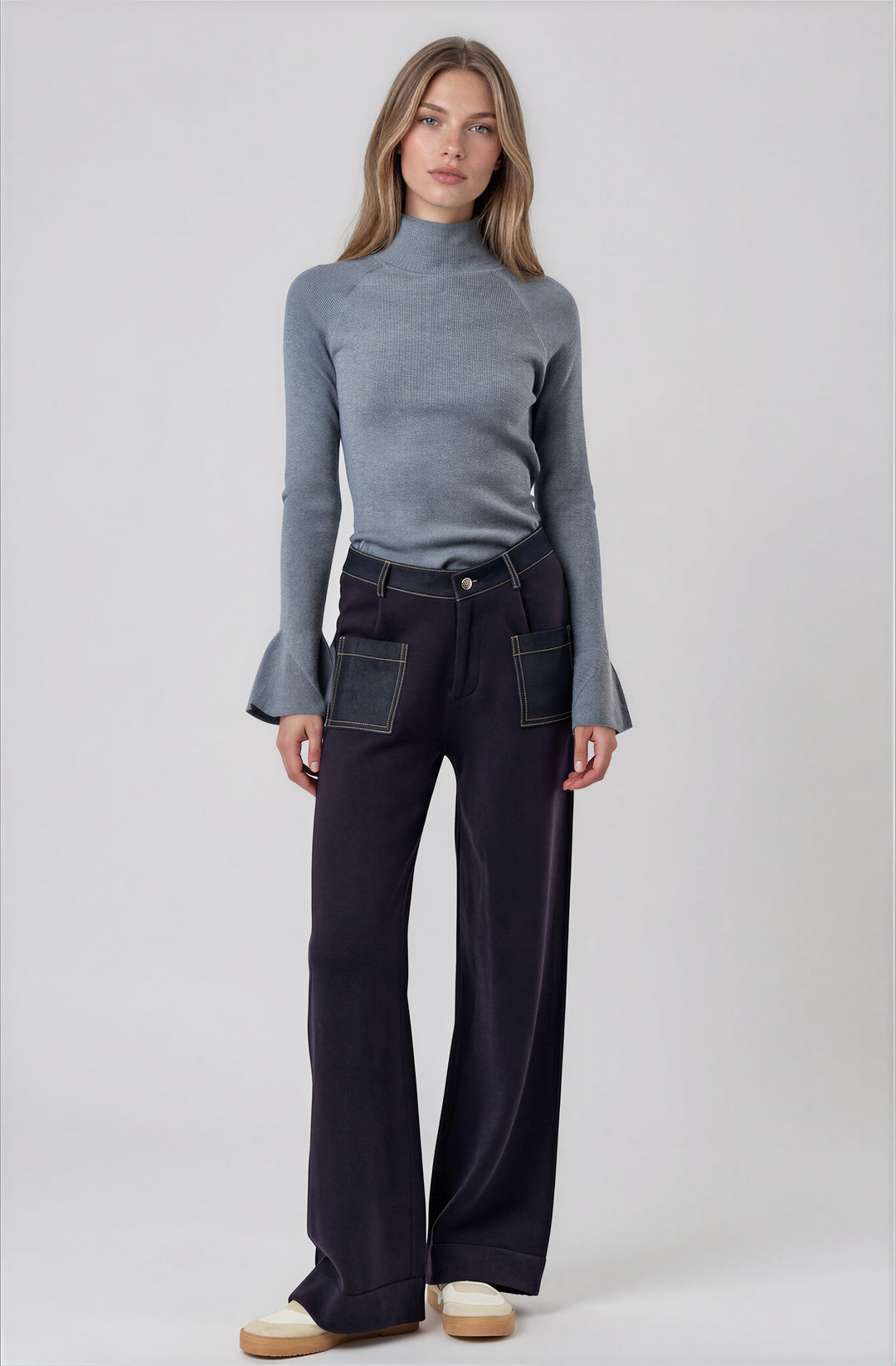 Gray ribbed mock neck sweater with tulip bell sleeves on model