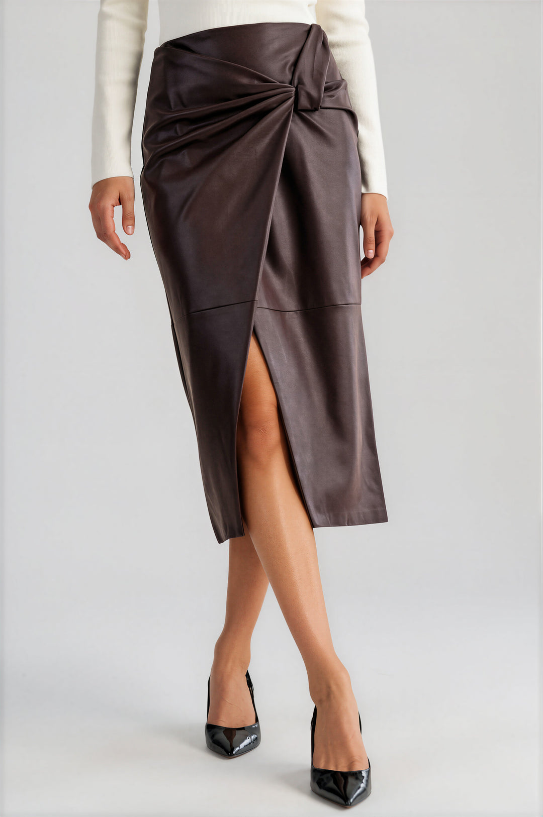 Brown vegan leather knot-front wrap skirt in a midi pencil silhouette #color_brown