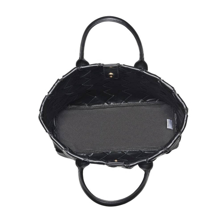 Black quilted handbag with a handle on a white background