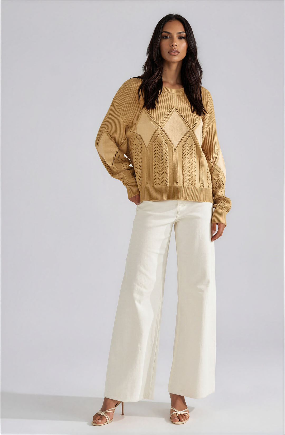 Beige textured pullover sweater with diamond knit pattern on model