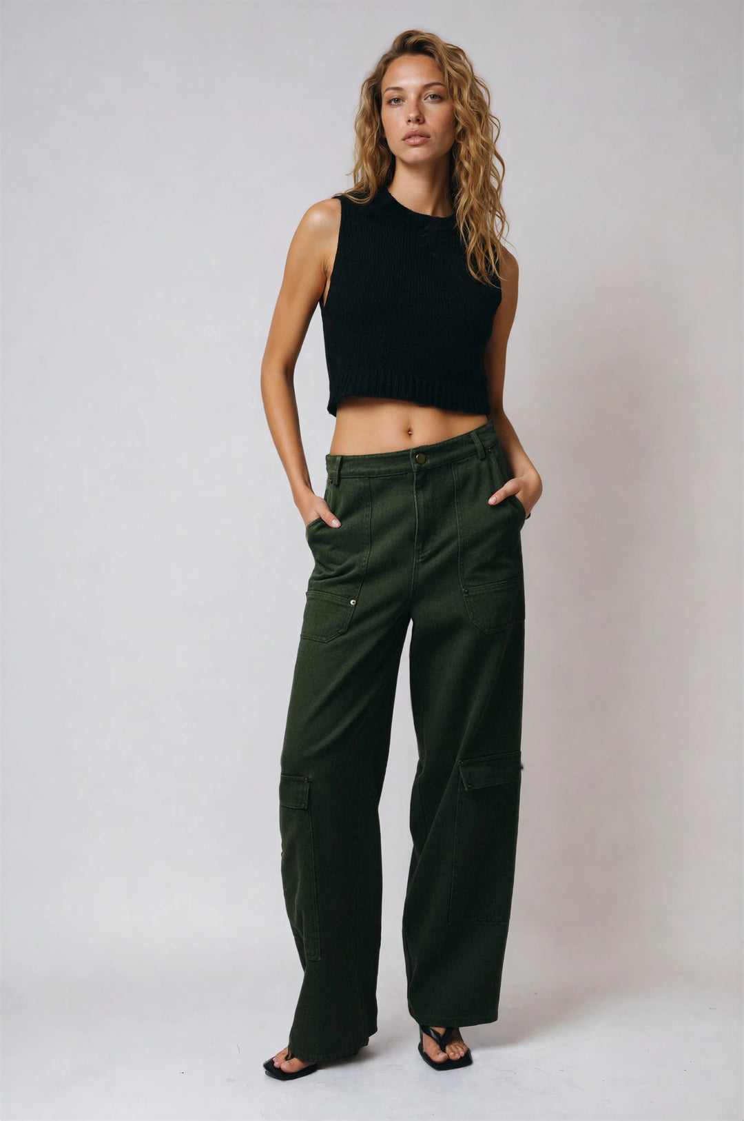 Olive barn jacket with contrast collar and plaid cuffs on model