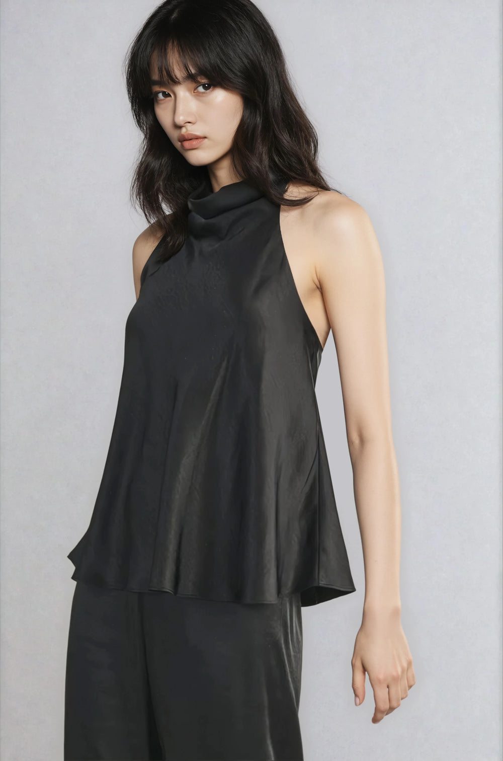 Front view black draped neckline blouse on model