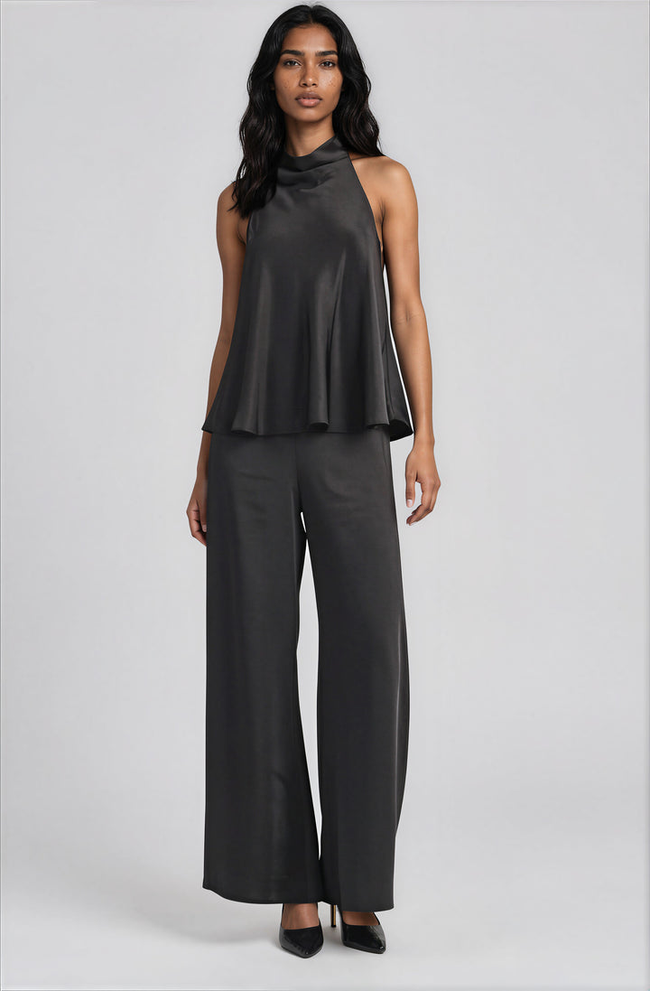 Black halter style satin draped mock neck blouse on model