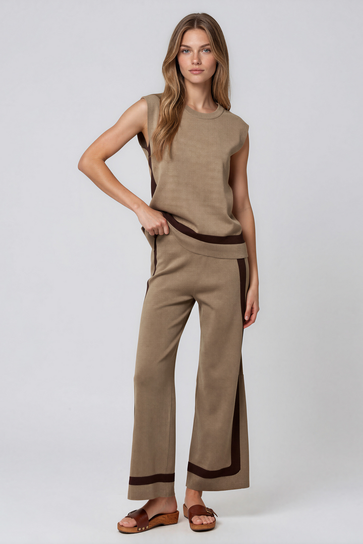 Woman wearing taupe knit sleeveless top and matching wide-leg pants set with contrast brown stripe detail