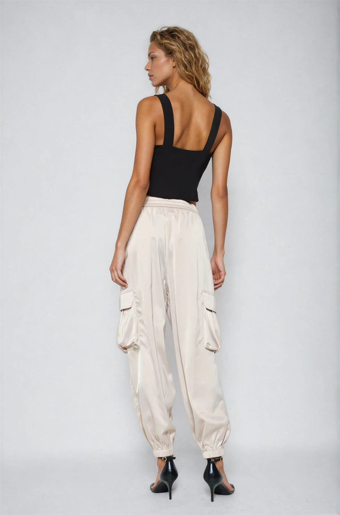 Off white sleeveless swing top with tweed finish on model