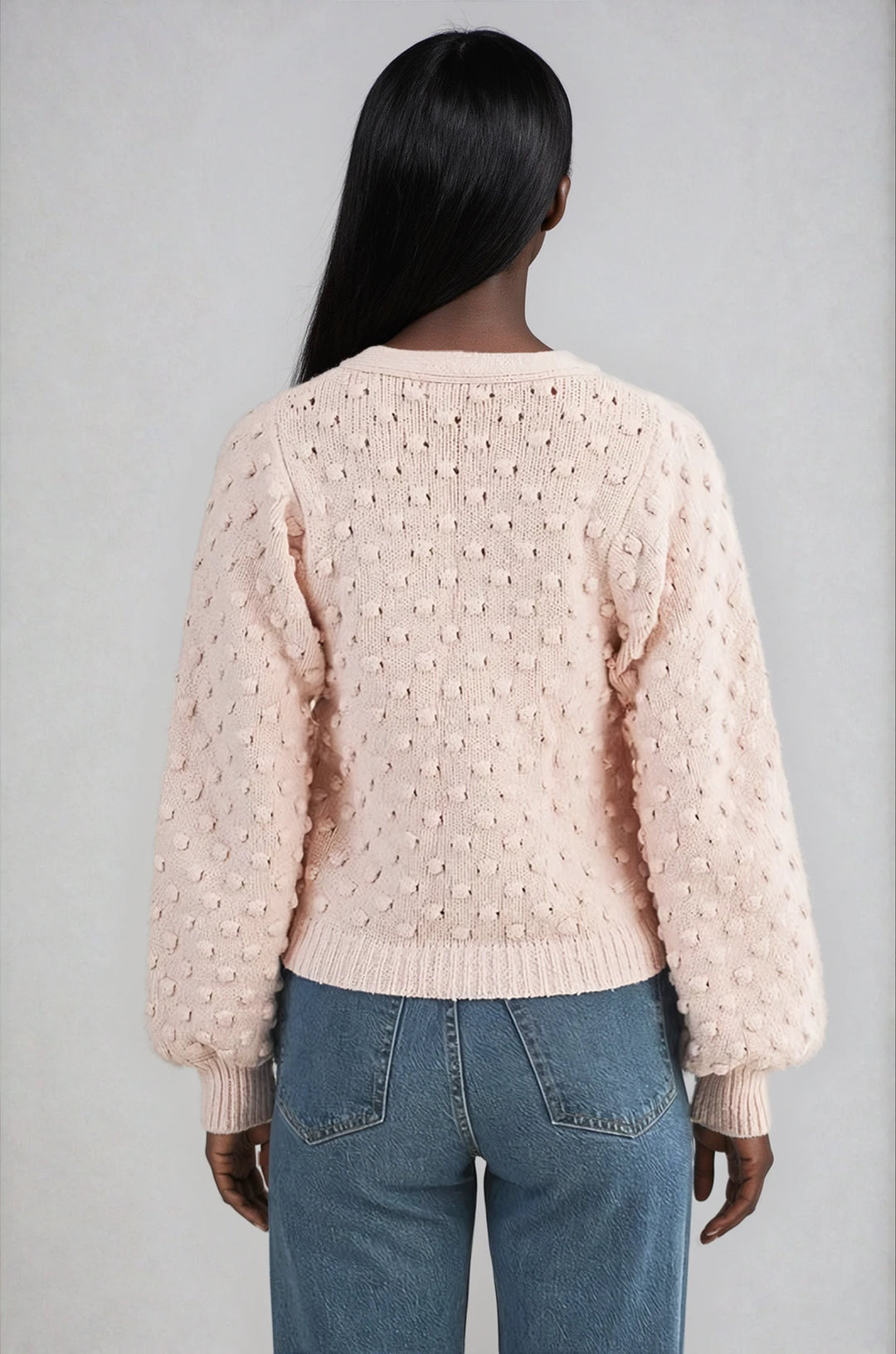 Back view pink textured cardigan with ribbed cuffs on model