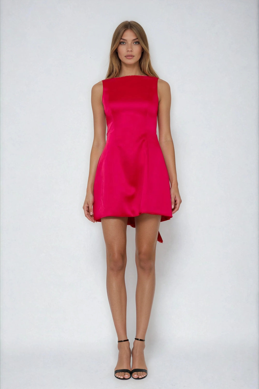 Red fit and flare mini dress with back bow on model