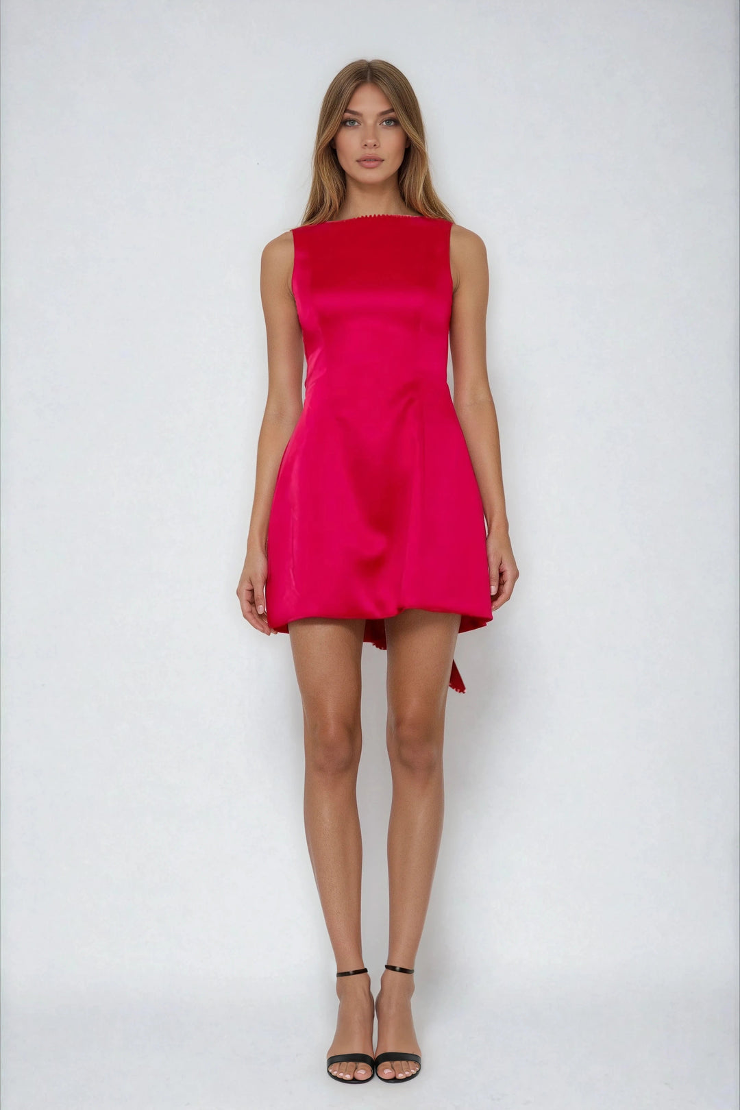 Red fit and flare mini dress with back bow on model