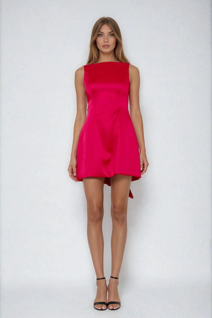Red fit and flare mini dress with back bow on model