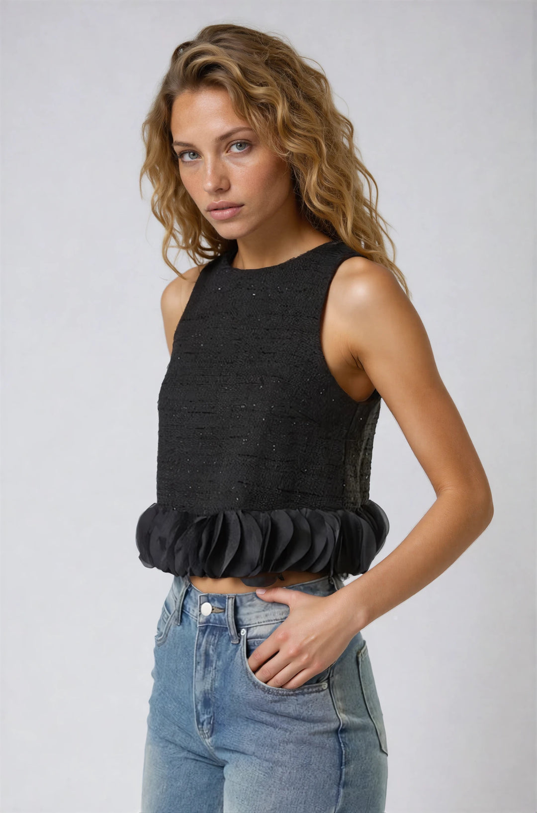 Front view black ruffled hem swing top on model