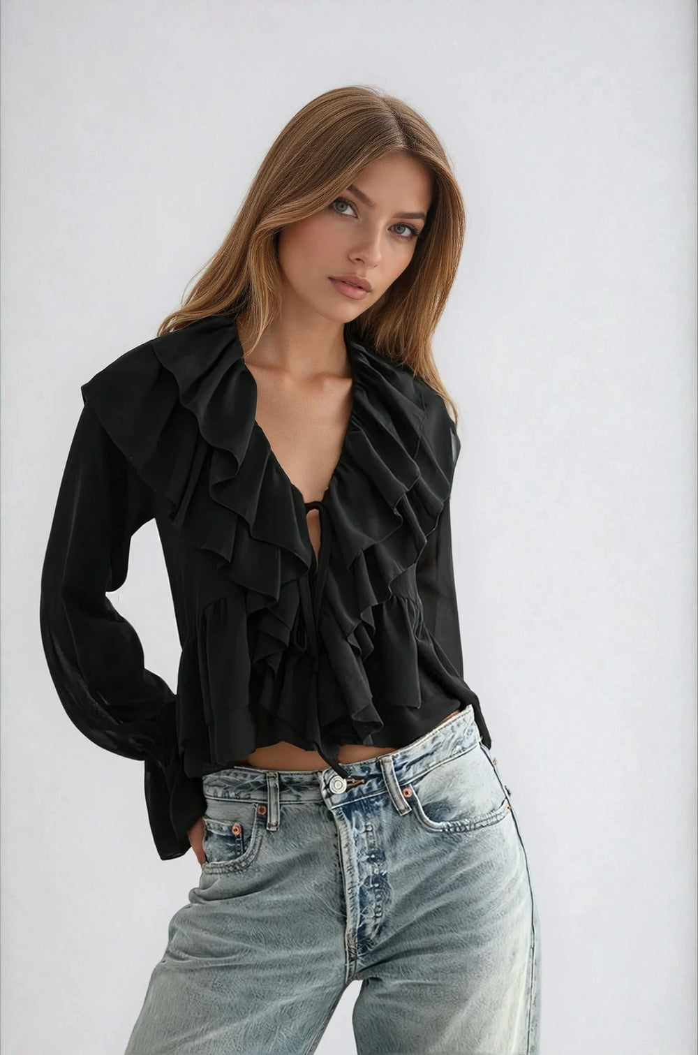 Front view black ruffled tie front blouse on model