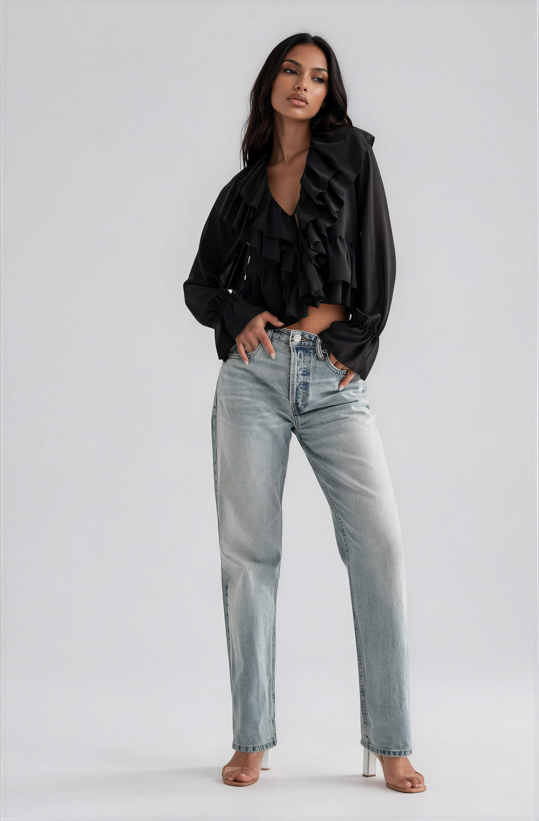 Black semi sheer blouse with cascading ruffles on model