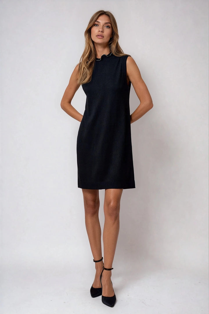 Black sleeveless sweater dress with mock neckline on model