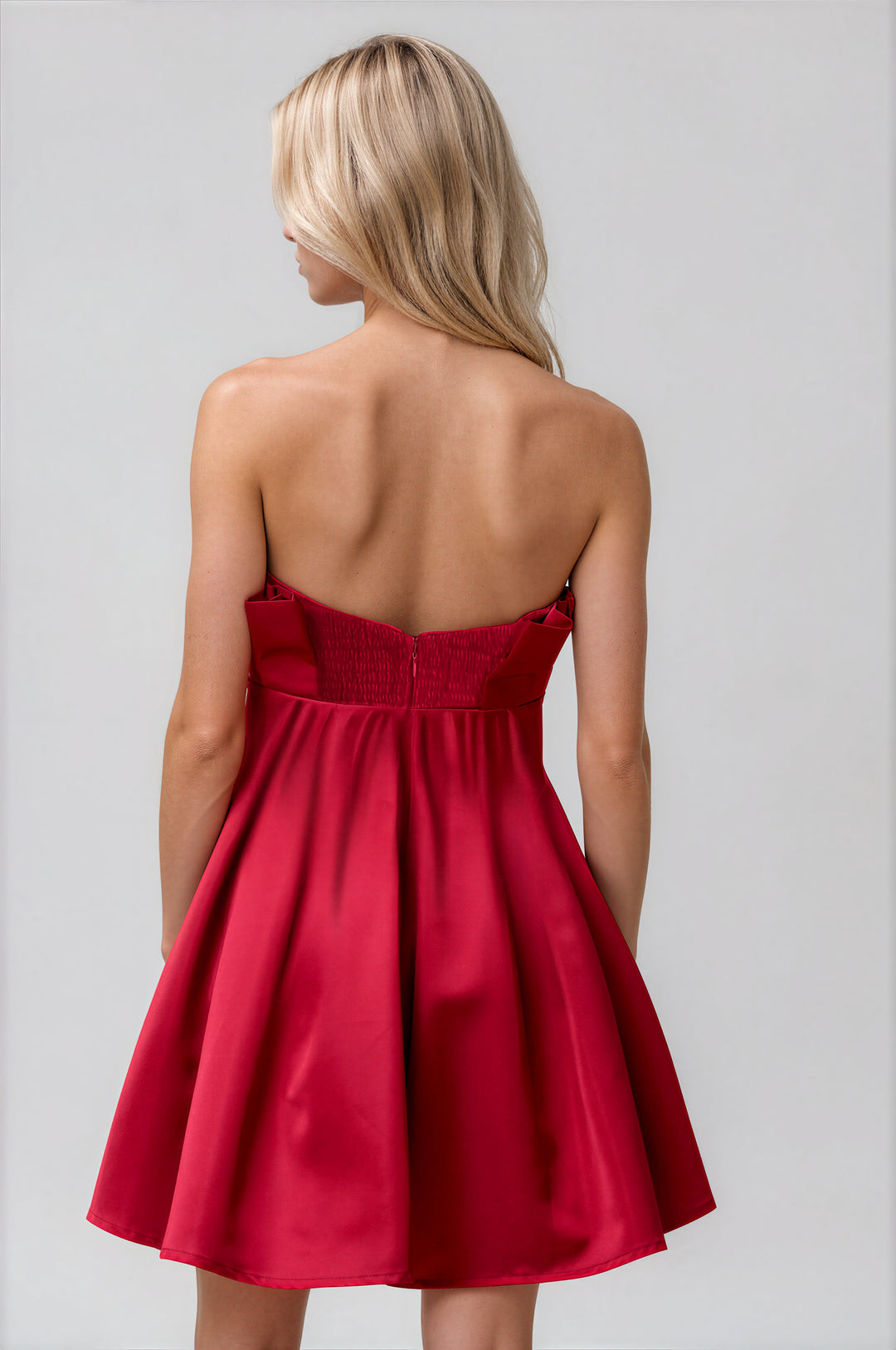 red strapless flared mini dress with pleating for holidays back view