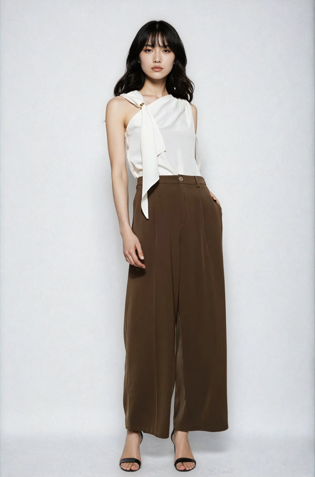 Ivory asymmetric sleeveless blouse with gold ring neckline on model